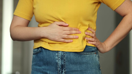 Woman touching his stomach. Stomach pain and others stomach disease concept.Girl having a...