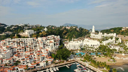 Naklejka premium Manzanillo, Mexico - 11.21.2022 Aerial view of Peninsula de Santiago in city Manzanillo, Mexico. Beautiful luxury hotels and boat and yacht berth