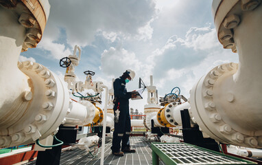 Male worker inspection at steel long pipes and pipe elbow in station oil factory during refinery...
