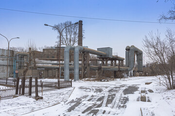 Plant for producing and supplying heat. Heat Pipes. Pipeline above ground, conducting heat to heat city. Open laying on pillars. Municipal Pipes supply