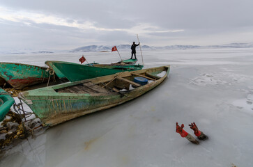 fishing boats on the shore of lake