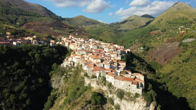 The ancient village of Tortora on top of its green mountain in Europe, Italy, Calabria, in summer on a sunny day.