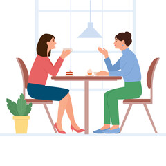 .Smilling women sit at the table and chat in a cafe. Female friends drinking tea ot coffee together. People enjoying coffee break in public place, having tea in restaurant,conversation, eating. 