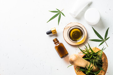 Cannabis cosmetic products on white. Natural cosmetic. Cream, soap, serum and others. Flat lay image with copy space.