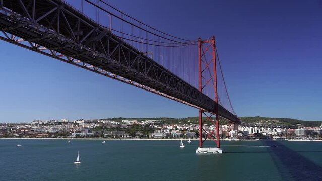 going under suspension bridge tagus river lisbon portugal. Travel, vacation concept.