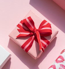 Gift boxes with red bow on the pink background. Valentine's day concept composition