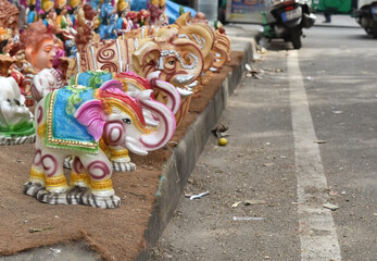 Obraz premium A selective focus picture of colorful ceramic or porcelain made Elephant dolls sold on Streets