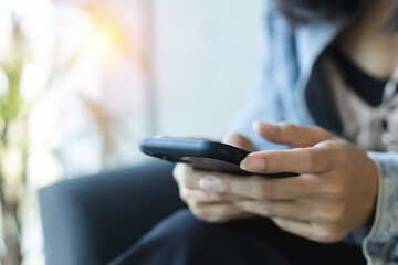 Close-up female hands using smartphone at table coffee cafe. chatting sending message online search social networks concept. communication cellphone digital telephone.