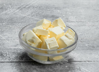 Butter in a glass bowl .