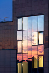 wall of a modern building. sunset reflection in the window