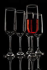 glasses with a light outline and one filled with a drink