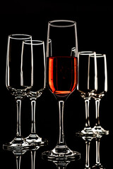glasses with a light outline and one filled with a drink