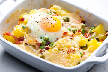 potatoes baked with smoked meat, green peas and cheddar cheese served with fired egg