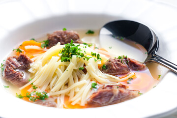 beef broth with noodles and carrot
