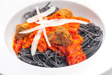 black spaghetti with tomato sauce with meat balls