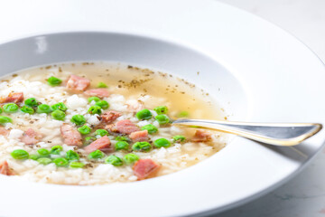broth of smoked meat with green peas and rice