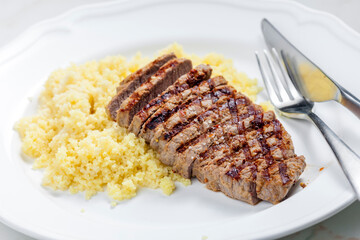 beef steak served with couscous