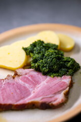 smoked meat with spinach and potato dumplings