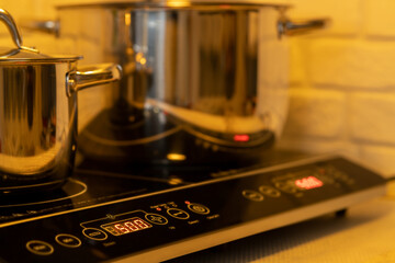 Metal Pot on induction hob in modern kitchen