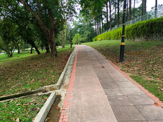 KUALA LUMPUR, MALAYSIA -JULY 6, 2022: Pedestrian path in a public park. Providing comfort for the public to stroll or have fun in the public park. Comfortable and spacious.