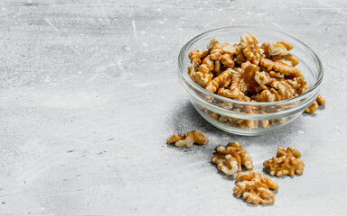 Walnuts in a glass bowl .