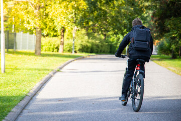 Bicycler riding a bike during summer day at park