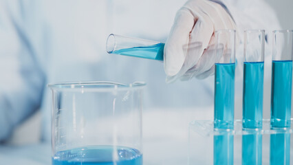 Scientist experimental in laboratory with test tube and beaker for medical research