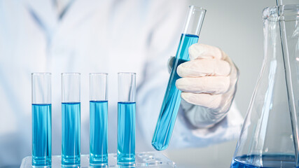 Scientist experimental in laboratory with test tube and beaker for medical research