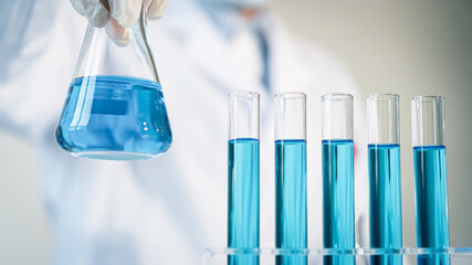 Scientist experimental in laboratory with test tube and beaker for medical research