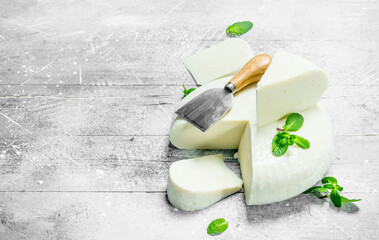 Soft sheep cheese with fresh mint leaves.