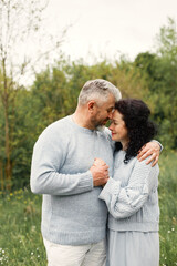 Fototapeta premium Senior couple standing in a park and looking on each other
