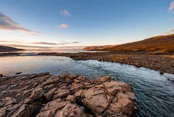 Rising sun at a sandy beach with beautiful rocks in the Westfjords in the morning, Iceland, stock photo, Europe