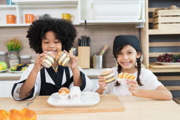 Happy two child girl enjoy with sweets paradise bakery in the kitchen