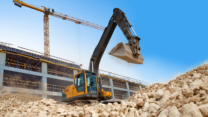 Crawler excavator. Special equipment for construction. Crawler excavator near unfinished building....