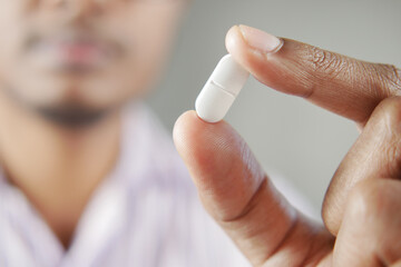 Close up of man hand holding pills with copy space 
