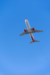 Travel, aviation passenger airplane flying in blue sky, bottom view