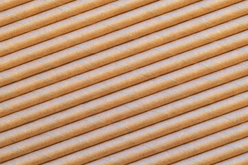 Paper straws arranged diagonally to fill a frame and make a background texture