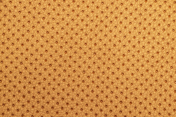 Closeup of perforated golden leather texture