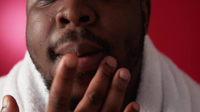 Lip care. Cold sore. Skin hygiene. Dermatology treatment. Cropped closeup of man applying face ointment cream with fingers on red.