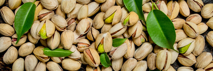 Pistachios with leaves texture .