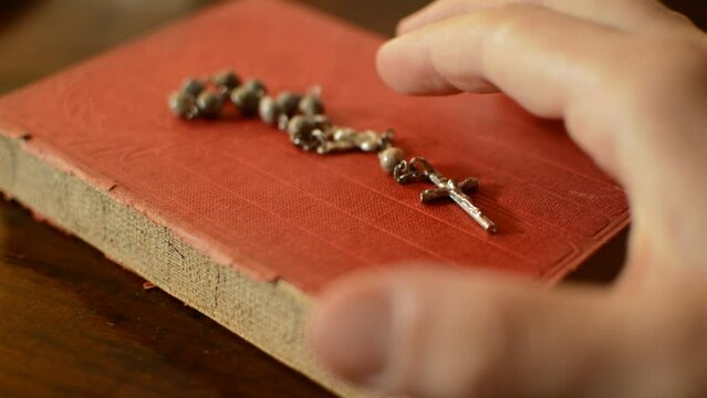 catholic man's hand turning biblia's page. flipping holy biblia's page.