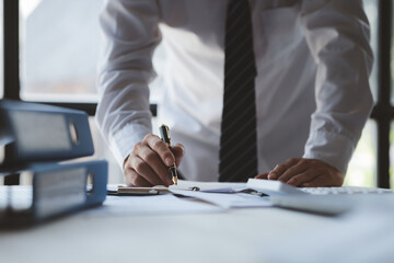 The sales department is having a monthly summary meeting to bring it to the department manager, they are verifying the correctness of the documents that are prepared before bringing in to the manager