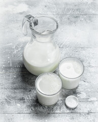 Fresh milk in a jug and glasses.
