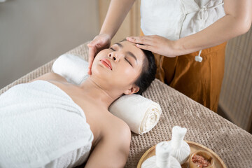 Fototapeta na wymiar Young Asian beauty woman enjoying massage and spa.