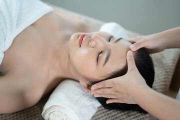 Obraz na płótnie Canvas Young Asian beauty woman enjoying massage and spa.