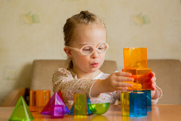 A girl with Down's syndrome lays out geometric shapes