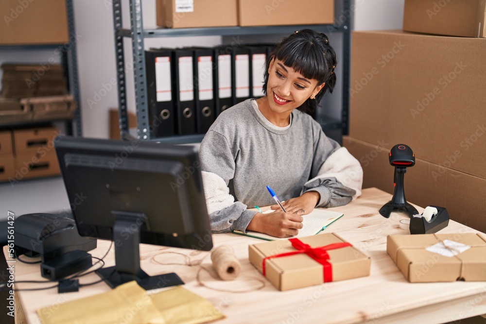 Sticker young woman ecommerce business worker writing on book working at office