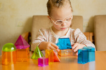 A girl with Down's syndrome lays out geometric shapes