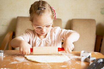 Girl with Down Syndrome learns to roll dough