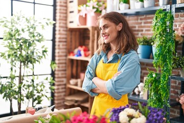 Young beautiful hispanic woman florist smiling confident standing with arms crossed gesture at florist